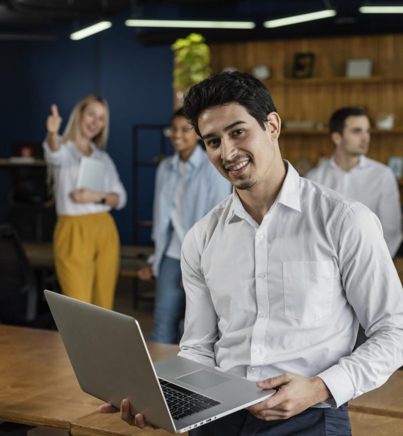 smiley-man-work-holding-laptop-posing